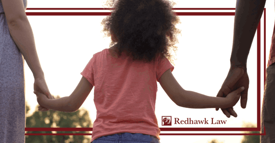 child holding hands with parents